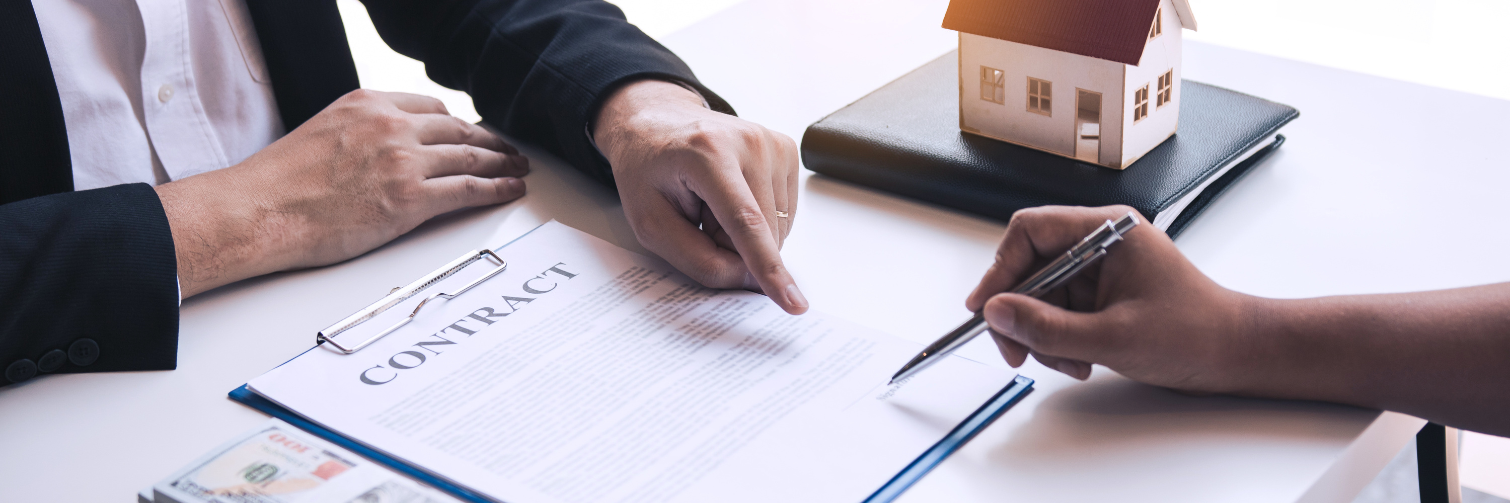Buyer Signing a Real Estate Contract with a Lawyer 